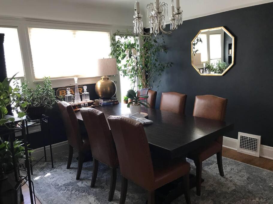 a dining room with a table and chairs and a mirror at Beautiful Luxury Suite A of Shorewood Home in Shorewood
