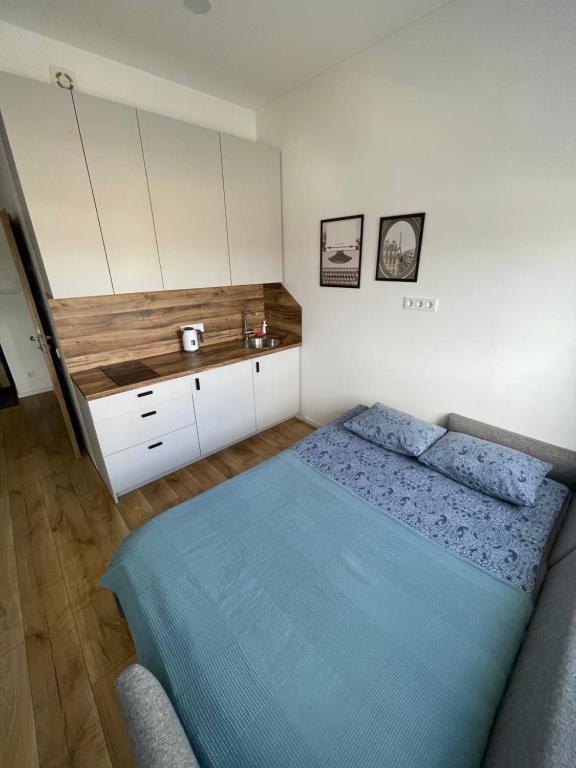 a bedroom with a bed and a sink at Airport Apartment 25 Self Check-In Fee Parking in Vilnius