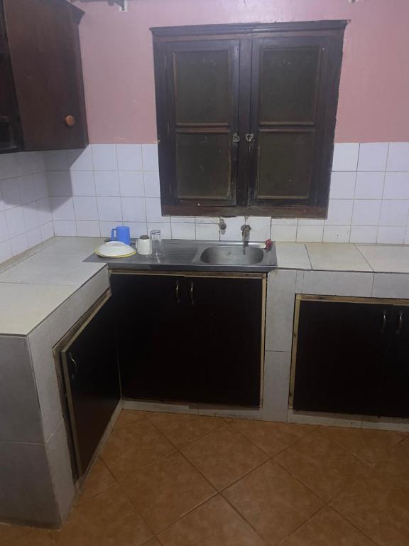 a kitchen with a sink and a counter top at PiperZ in Entebbe
