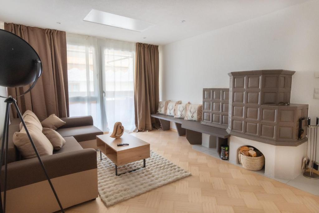 a living room with a couch and a table at Deluxe Apartement Tirol in Landeck