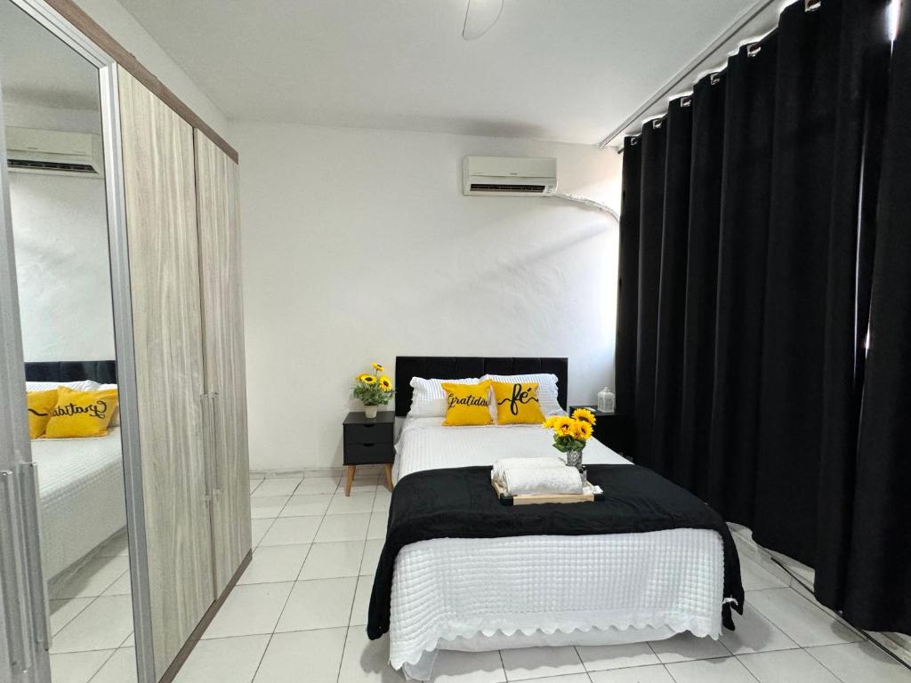 1 dormitorio con 1 cama con almohadas amarillas en Apartamento Copa Home HIR 3, en Río de Janeiro