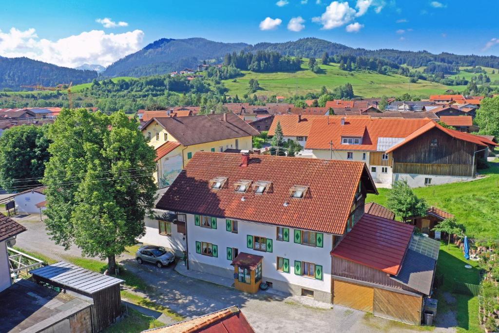 an aerial view of a village with mountains in the background at Landhaus Sonnwinkl in Wertach