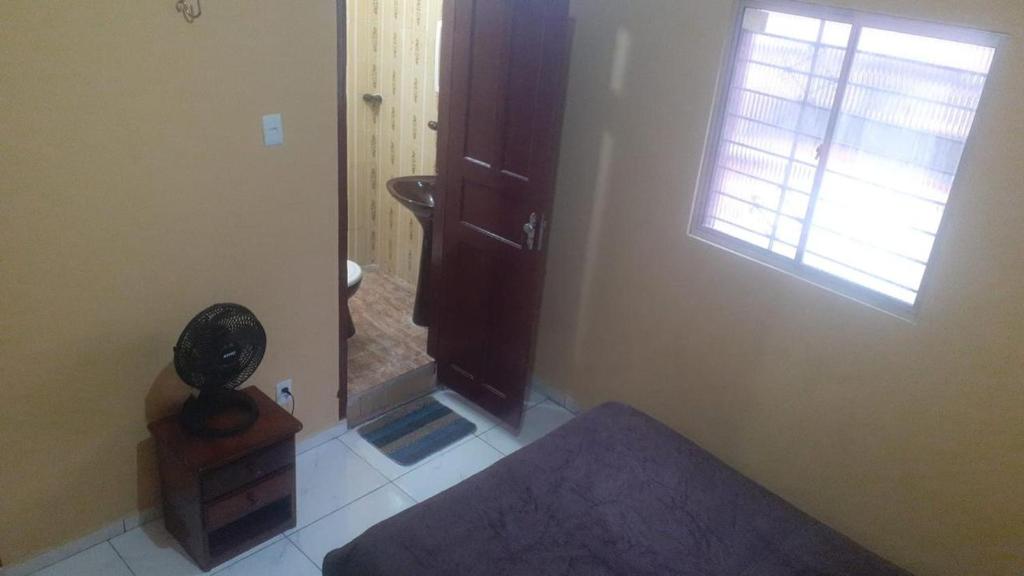 a bathroom with a sink and a toilet and a window at Carpe Diem Suítes in Belém