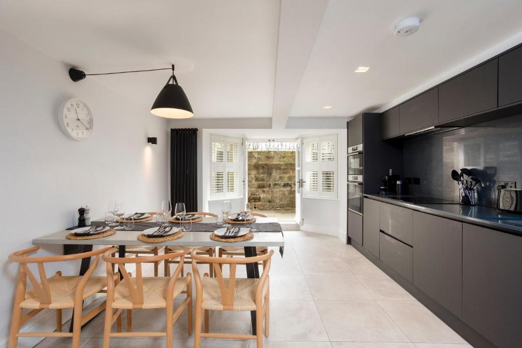 a kitchen with a table and chairs in a kitchen at Kist Accommodates - The Stray Nook in Harrogate