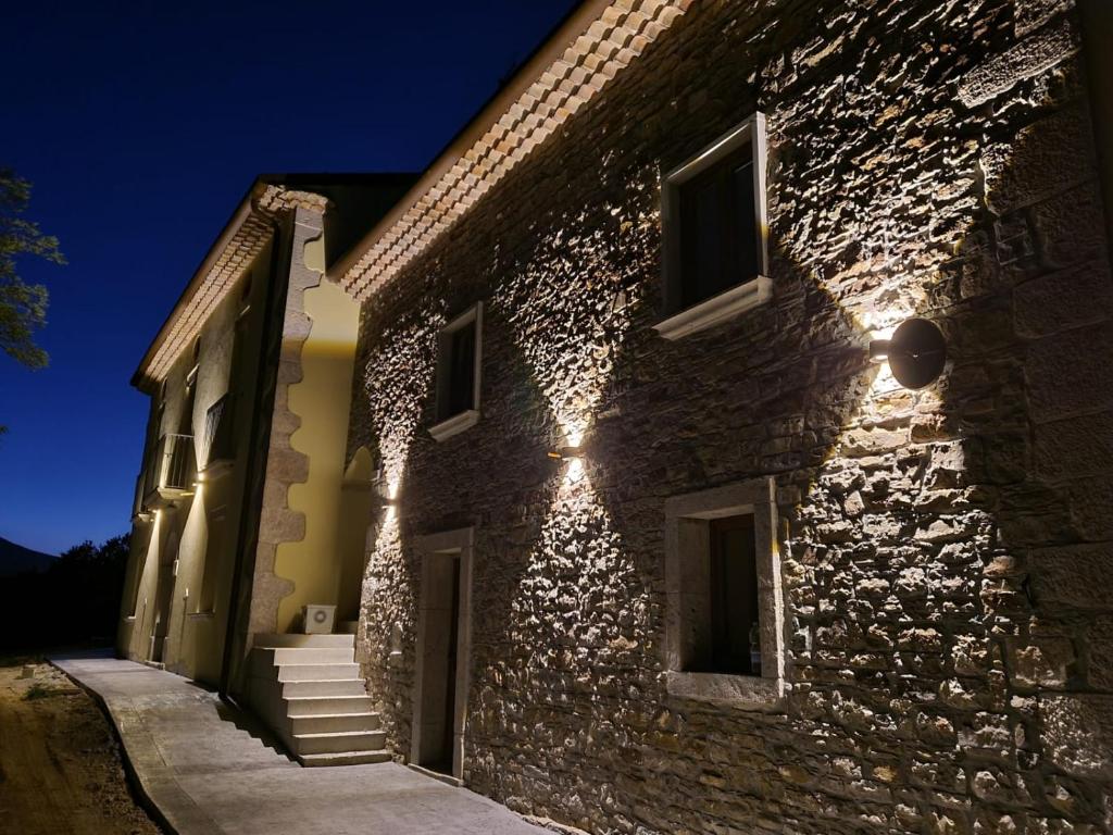 a stone building with lights on it at night at Tenuta Barone in Duronia