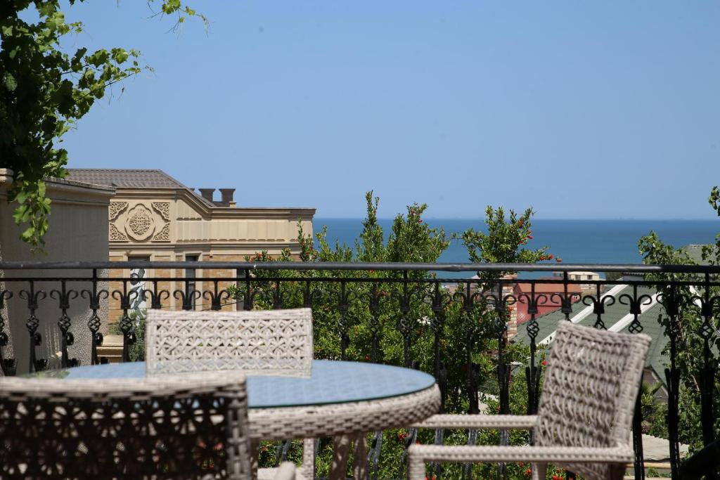 a patio with a table and chairs on a balcony at Seaview Villa Buzovna Sameya in Buzovna
