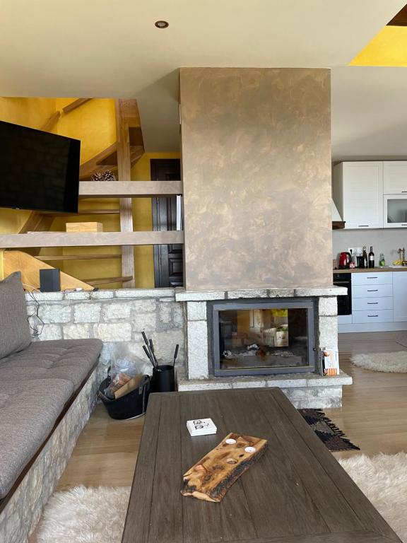 a living room with a couch and a fireplace at Delphi Gorge-view Chalet, Arachova in Arachova