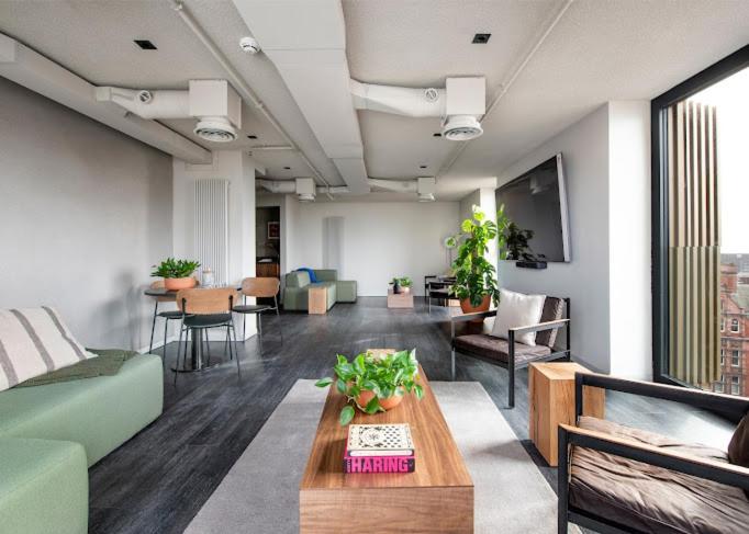 a living room with a couch and a table at Kampus in Manchester