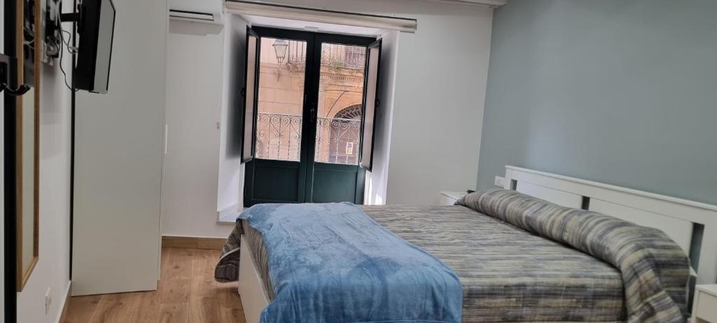 Un pat sau paturi într-o cameră la Le Antiche Porte
