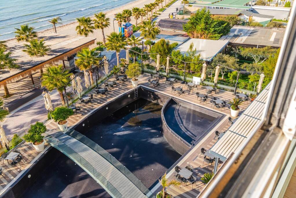 an overhead view of a pool with a beach and palm trees at Seaview Luxury Suite by PS in Golem