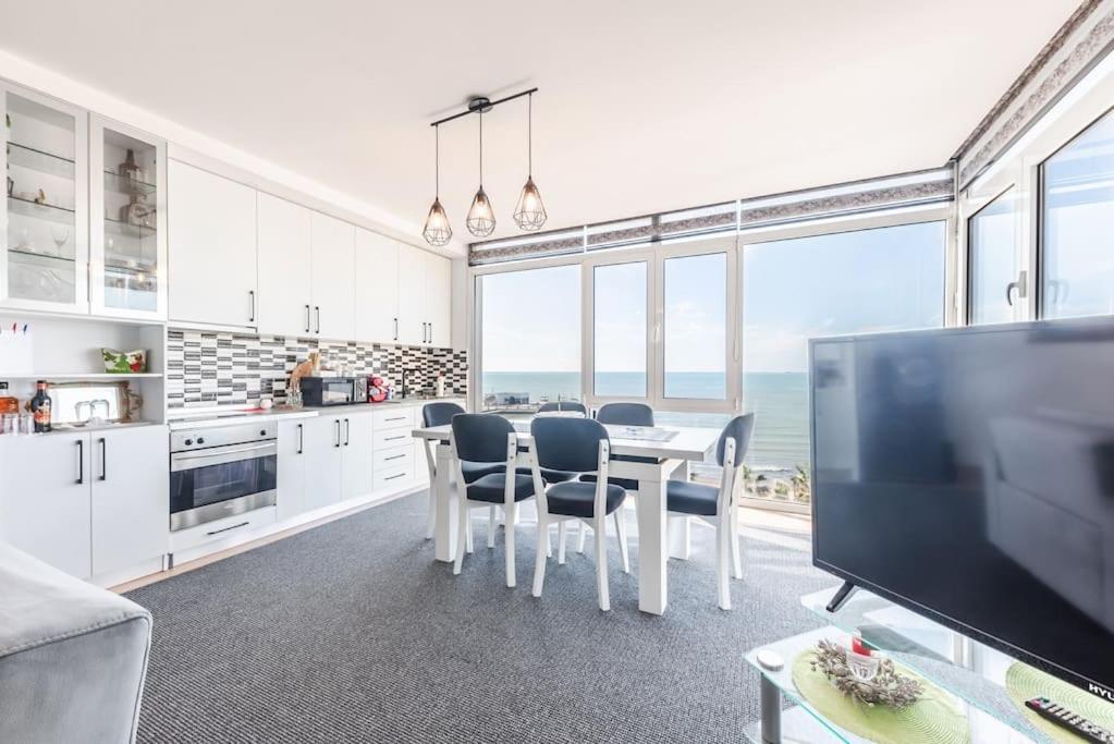 a kitchen with a table and chairs and the ocean at Seaview Luxury Suite by PS in Golem