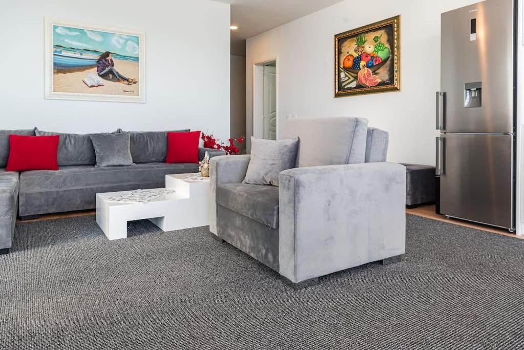 a living room with a couch and a refrigerator at Seaview Luxury Suite by PS in Golem