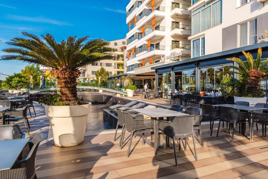 an outdoor patio with tables and chairs and a building at Seaview Luxury Suite by PS in Golem