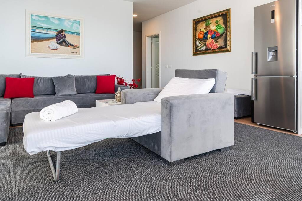 a living room with a couch and a refrigerator at Seaview Luxury Suite by PS in Golem