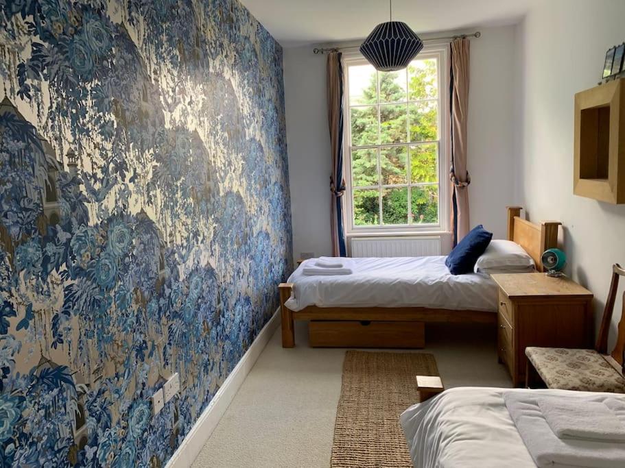 a bedroom with two beds and a wall mural at Seaside Holiday Home, Ramsgate, Latimer House in Ramsgate