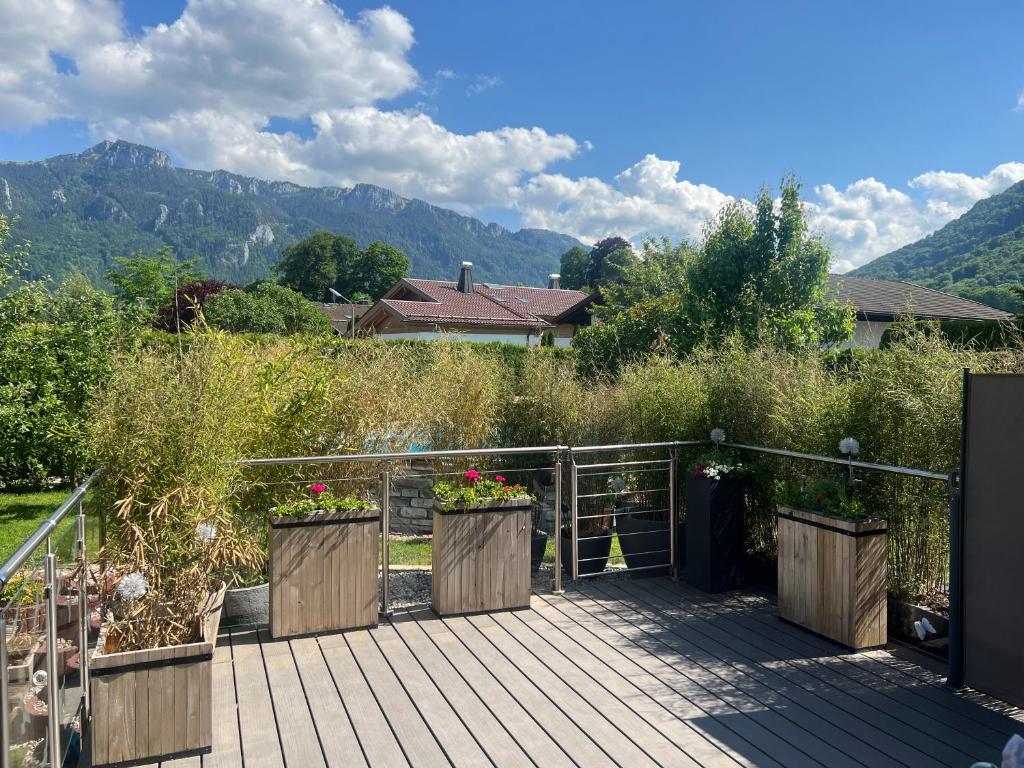 a wooden deck with flowers on it with mountains in the background at ciao-aschau FeWo Lexa in Aschau