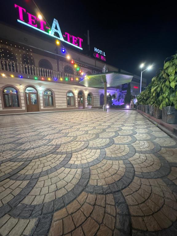 a stone walkway in front of a building at night at Tet-A-Tet in Qarasū