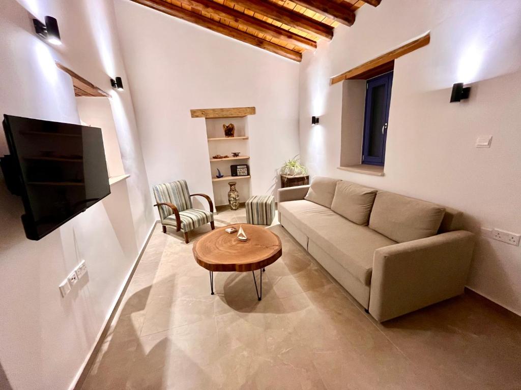a living room with a couch and a table at The Courtyard Episkopi Guest Houses in Episkopi Limassol