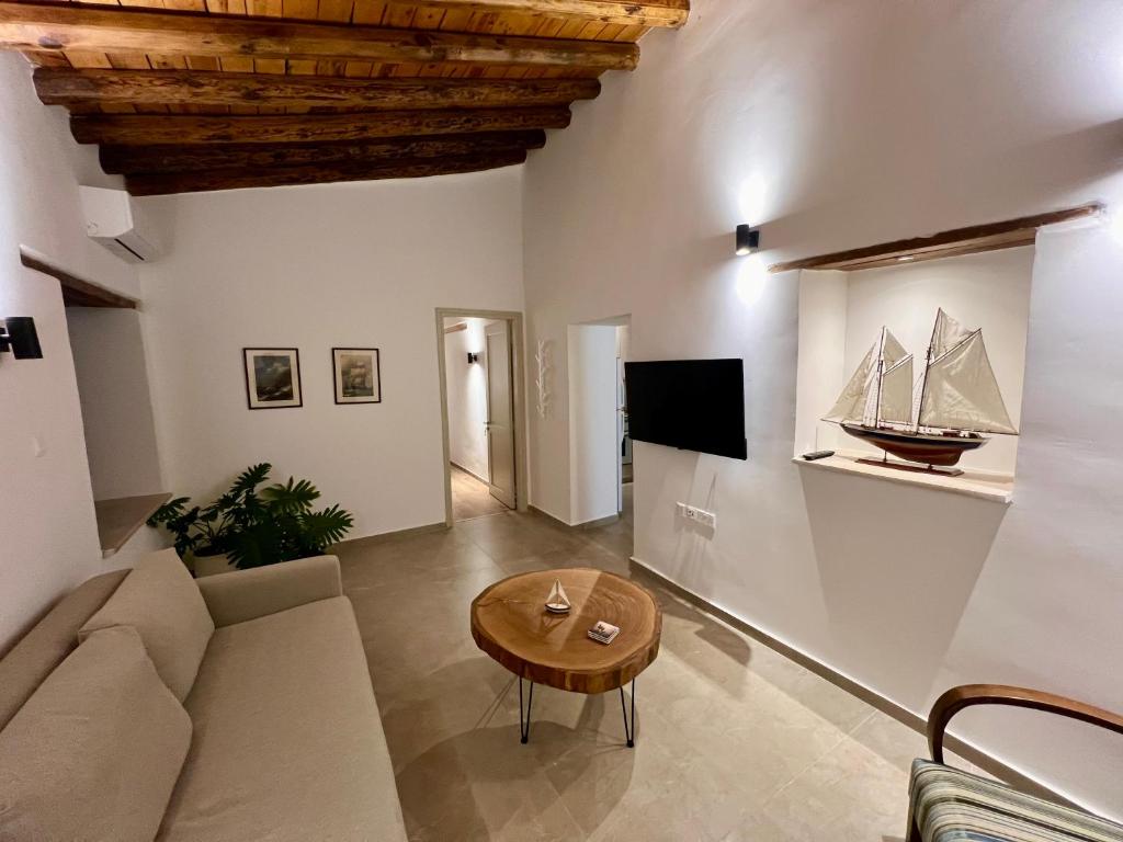 a living room with a couch and a table at The Courtyard Episkopi Guest Houses in Episkopi Limassol