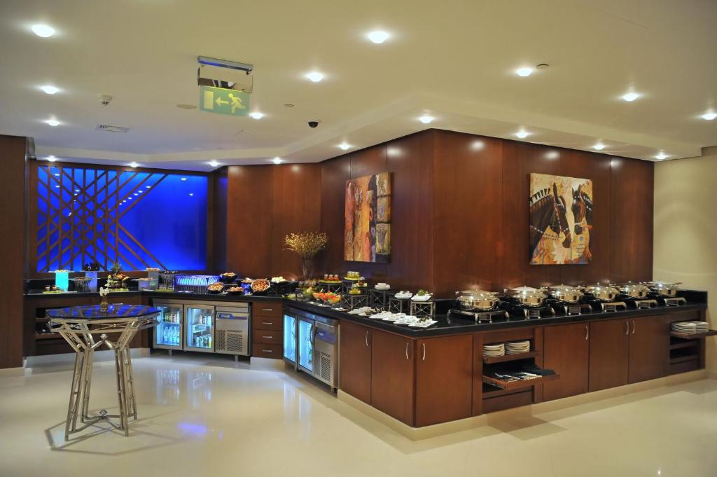a kitchen with a stove and a bunch of pots at Intercontinental Cairo Citystars by IHG in Cairo