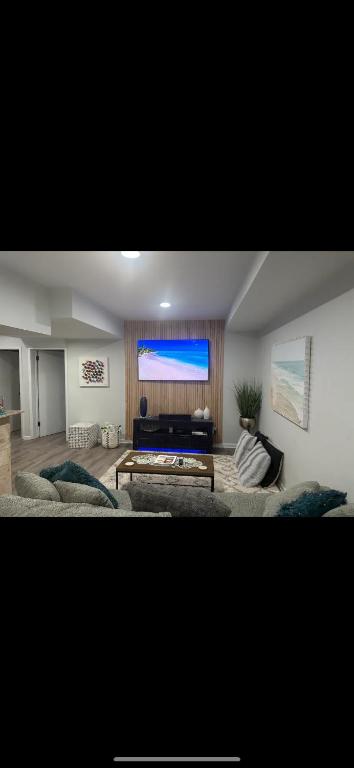 a living room with a couch and a large window at 2 bedroom Apt in long branch in Long Branch