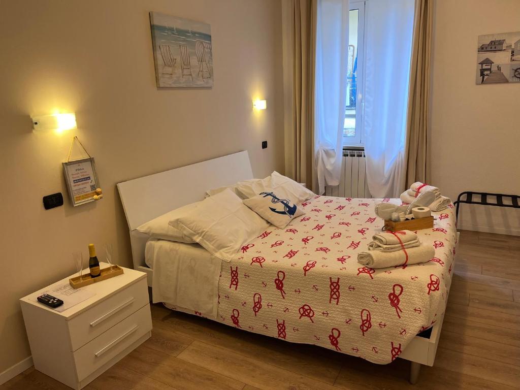 a small bedroom with a bed and a night stand at Affittacamere Il Veliero in Levanto