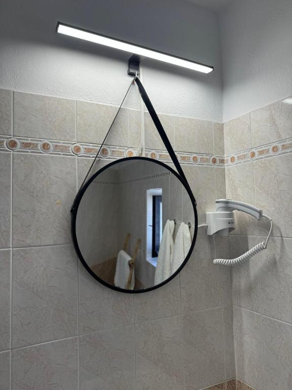 a mirror on a wall in a bathroom at O Mylos in Ermoupoli