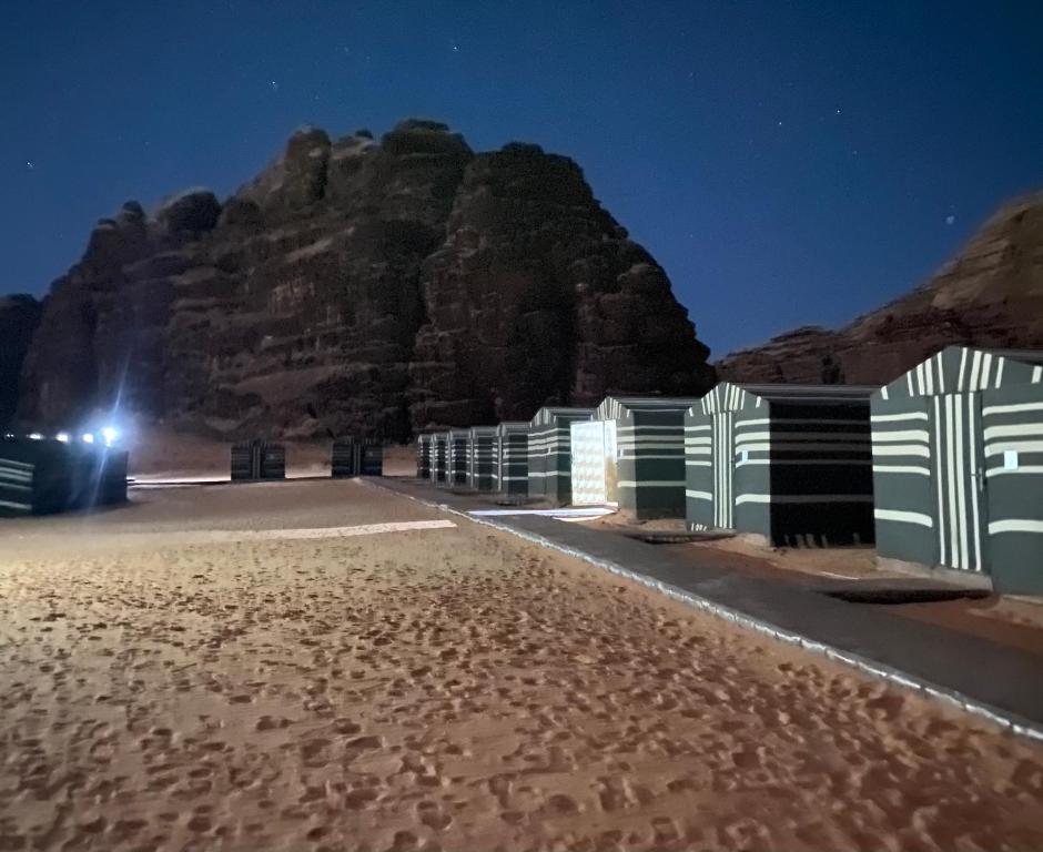 a mountain in the middle of a desert at night at Bedouin Memories Camp in Wadi Rum