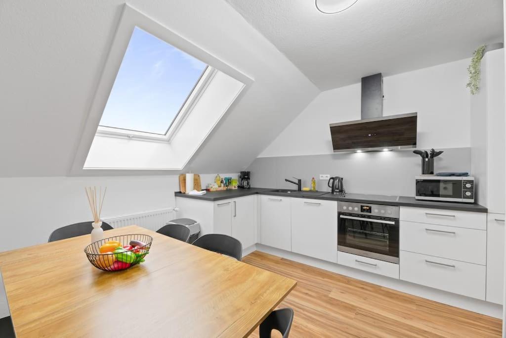 a kitchen with a table with a bowl of fruit on it at W02 Business Apartment für Teams in Wendlingen am Neckar