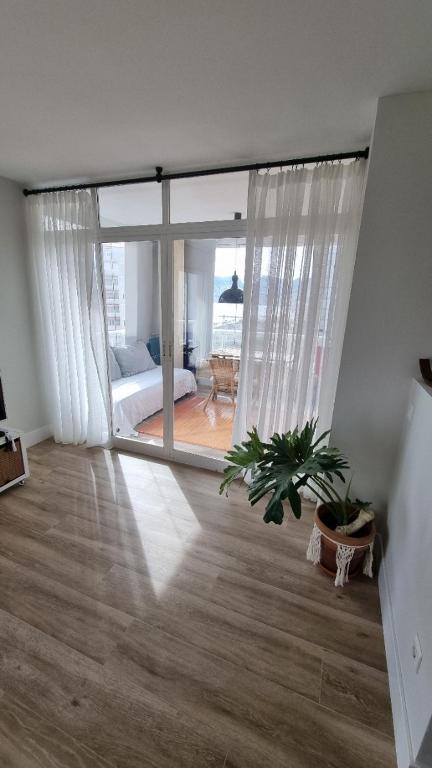 卡尔佩Atico Playa Arenal Calpe的客厅设有大窗户和植物