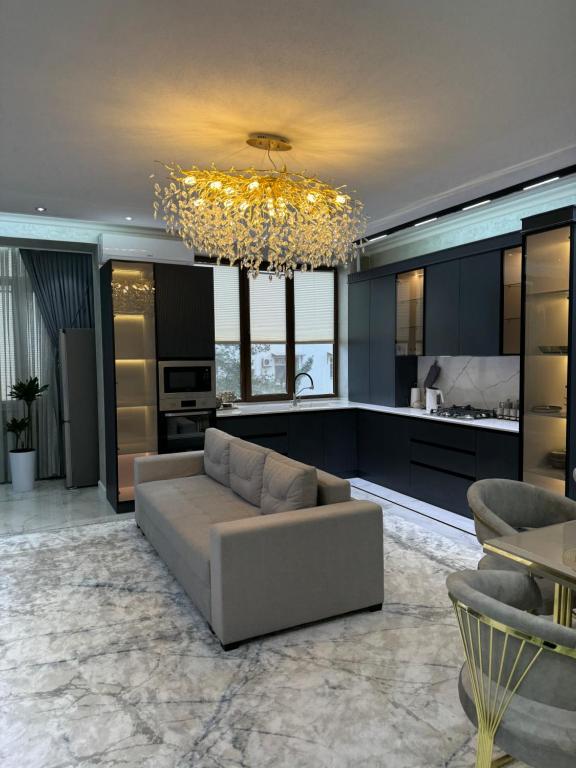 a living room with a couch and a chandelier at Lux 3-roomed apartment close to the Registan Amaliapartment in Samarkand