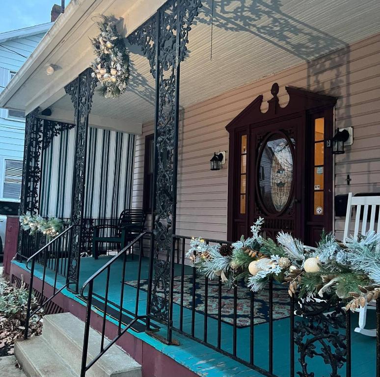 a porch of a house with a clock on it at Large, Bright Suite Kitchenette in Ligonier