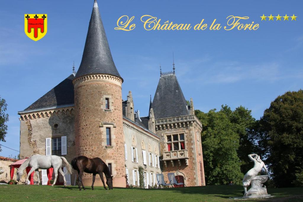 a castle with two horses standing in front of it at Château de la Forie in Saint-Étienne-sur-Usson