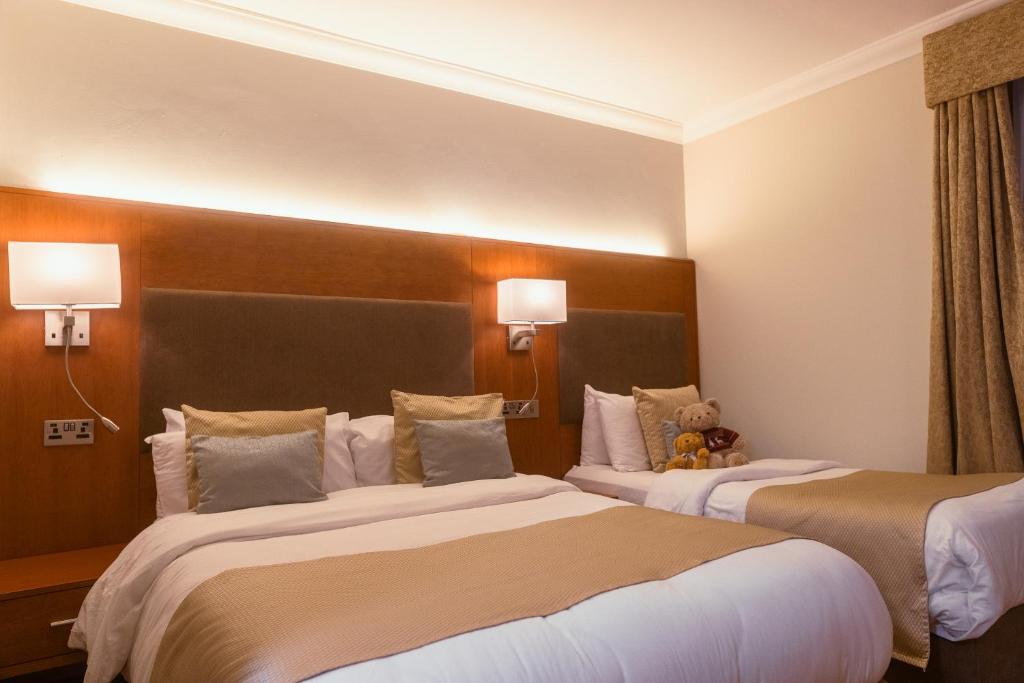 Ένα ή περισσότερα κρεβάτια σε δωμάτιο στο Uppercross House Hotel