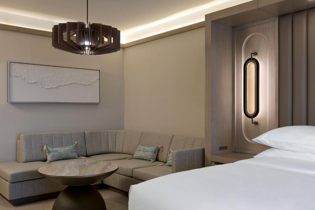 a living room with a bed and a couch at JW Marriott St Maarten Beach Resort & Spa in Dawn Beach