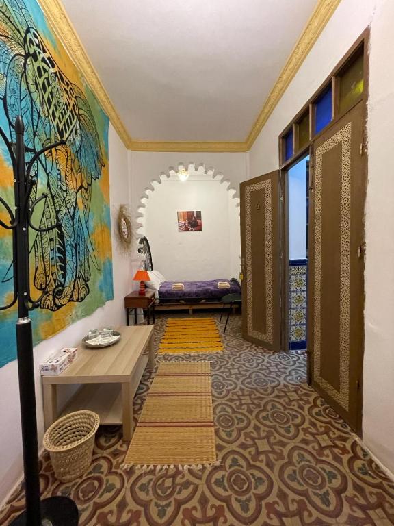 a hallway with a room with a door and a table at Dar Mora in Tangier