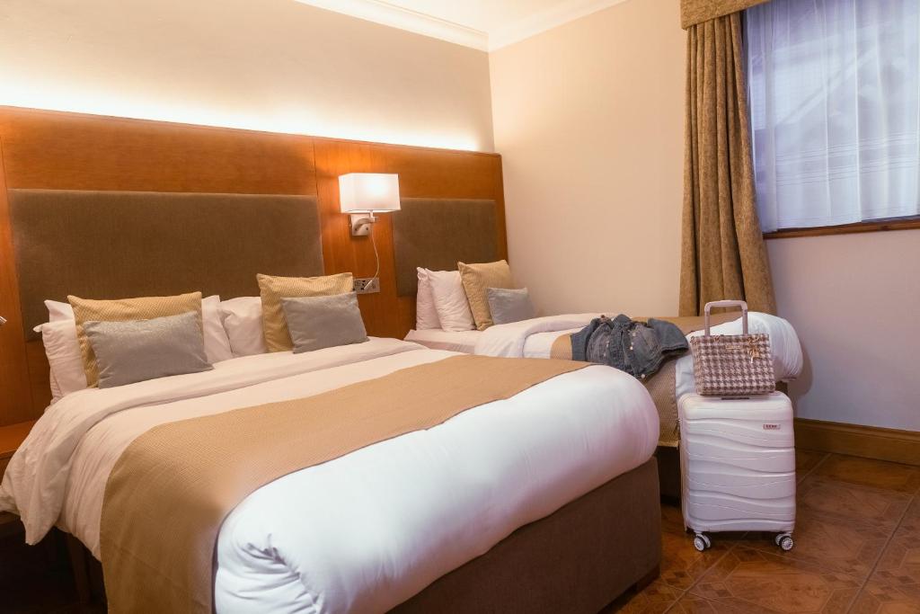 Ένα ή περισσότερα κρεβάτια σε δωμάτιο στο Uppercross House Hotel