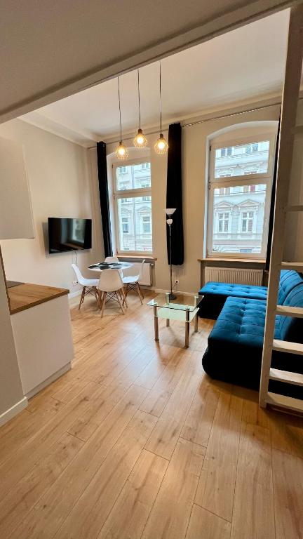 a living room with a couch and a table at Łokietkowo Apartamenty Szczecin Centrum in Szczecin
