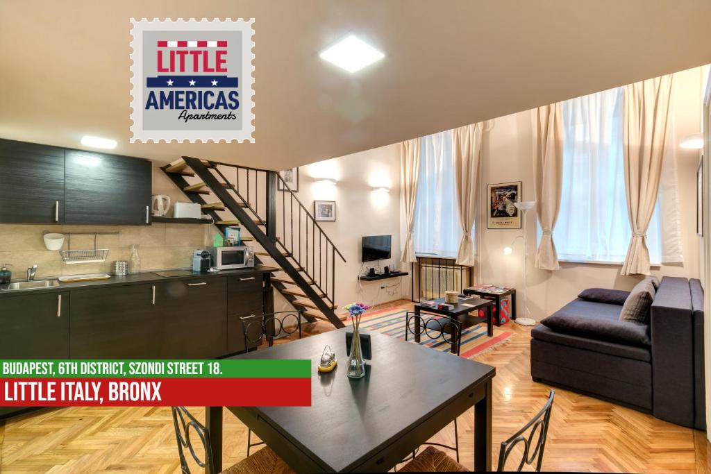 een woonkamer met een tafel, een keuken en een trap bij Little Italy Bronx Apartment in Boedapest