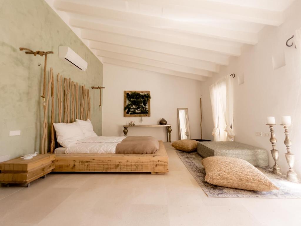 a bedroom with a large bed and a table at Casa Timbale in Felanitx