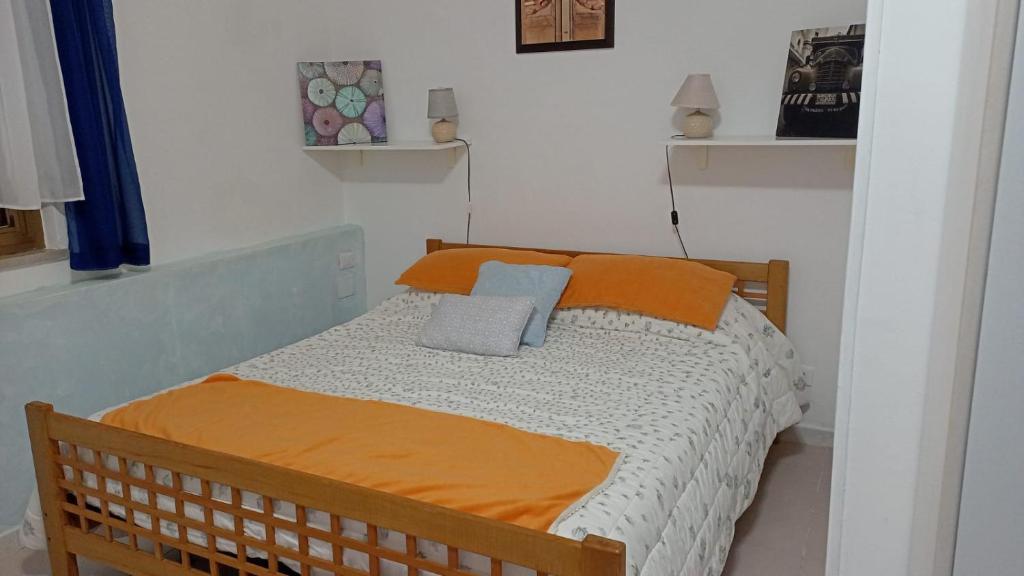 a bedroom with a bed with two pillows on it at Country House Gaeta in Gaeta