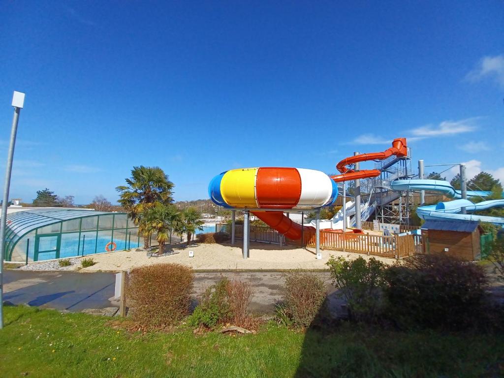a water park with a slide and a water slide at Mobil home équipé camping 5* in Houlgate
