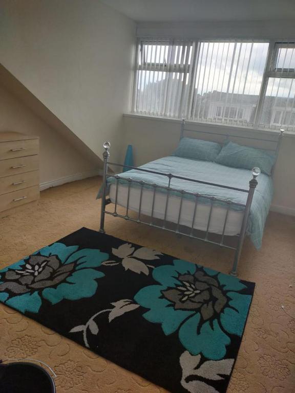 a bedroom with a bed and a rug on the floor at Female Only Room in Bradford