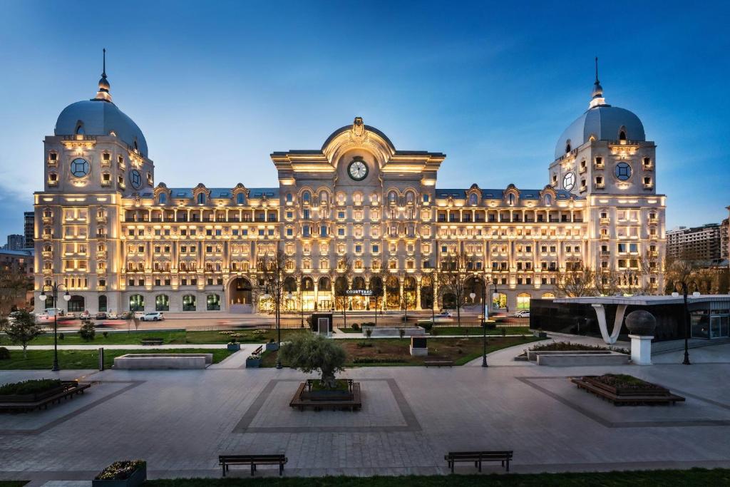 a large building with a plaza in front of it at Courtyard by Marriott Baku in Baku