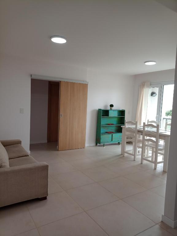 a living room with a couch and a table at Departamento Del Valle in Tandil