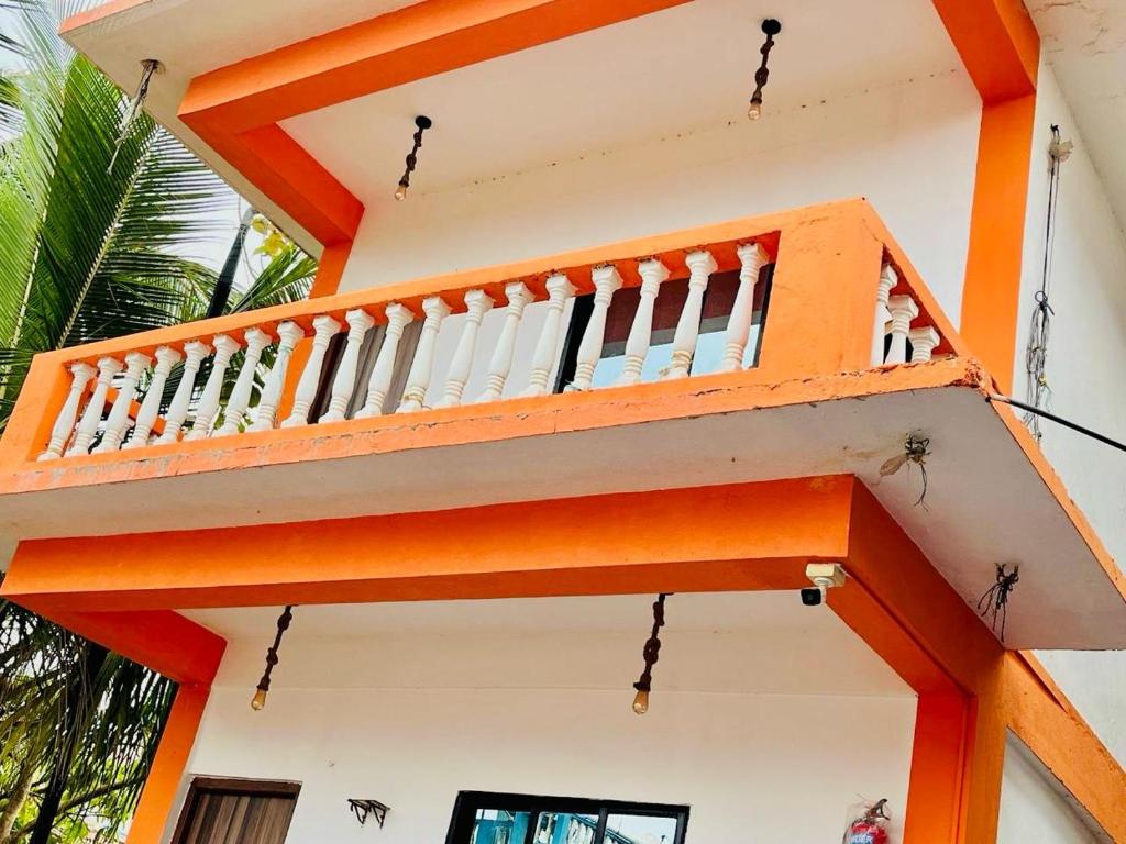 an orange and white house with spiders on it at La Pescador Home Stay, Baga in Baga