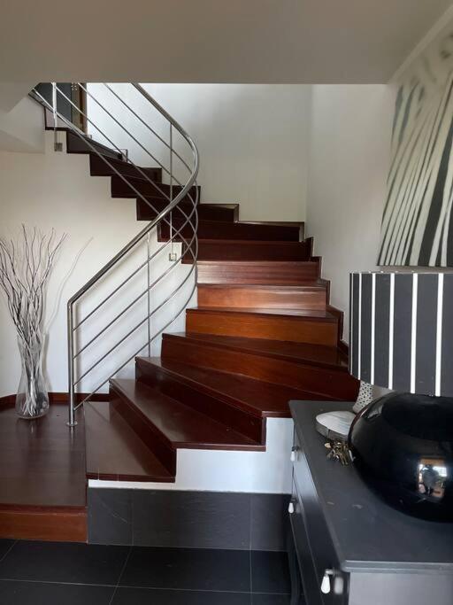 a staircase in a house with wooden floors at Punta Salera house & beach in A Pobra do Caramiñal
