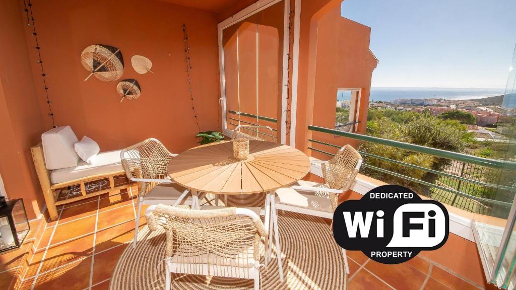 a patio with a table and chairs on a balcony at Bellavista 5E in Manilva