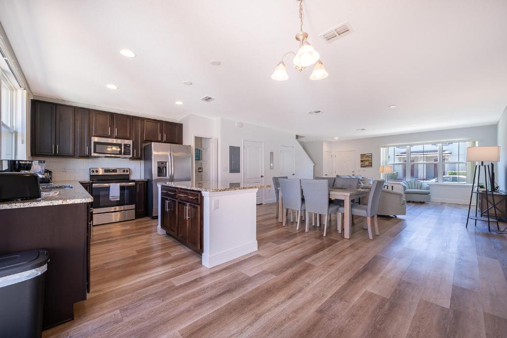 a kitchen and living room with a table and chairs at Home with amenities - Family vacation in Orlando in Kissimmee