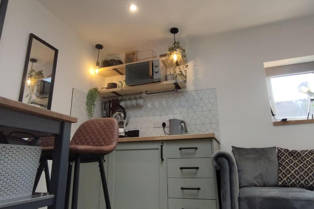 a small kitchen with a counter and a microwave at The Nook: Self Contained Annex in Taunton